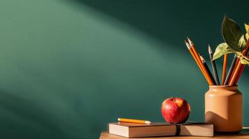 Classroom Supplies With Apple and Pencils on Wooden Table Against Green Backdrop in Bright Sunlight photo