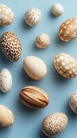 Decorative Easter Eggs Arranged on a Light Blue Background for Springtime Celebration. photo
