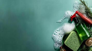 Cleaning Supplies Arranged With a Green Sponge and Soap Bubbles on a Dark Background. photo
