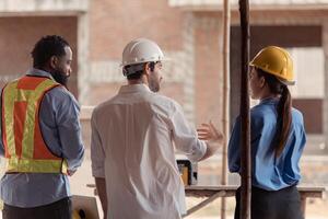 Group of architects and engineers work together to assess the residential home construction site's progress,200 photo