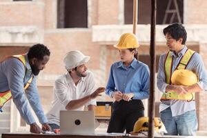 Group of architects and engineers work together to assess the residential home construction site's progress,182 photo