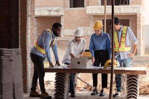 Group of architects and engineers work together to assess the residential home construction site's progress,181 photo