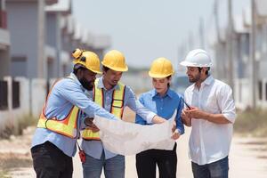 Group of architects and engineers work together to assess the residential home construction site's progress,178 photo