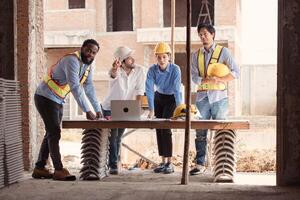 Group of architects and engineers work together to assess the residential home construction site's progress,155 photo