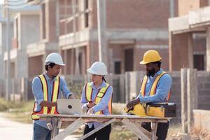 Group of architects and engineers work together to assess the residential home construction site's,142 photo