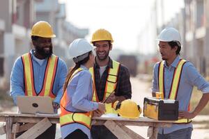 Group of architects and engineers work together to assess the residential home construction site's progress,132 photo