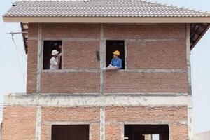 Architects and engineers work together to assess the residential home construction site's progress,80 photo