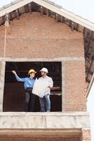 Architects and engineers work together to assess the residential home construction site's progress,48 photo