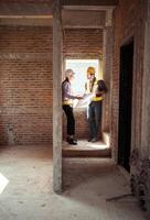 Architects and engineers work together to assess the residential home construction site's progress,45 photo