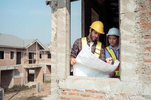 Architects and engineers work together to assess the residential home construction site's progress,24 photo