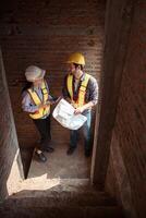 Architects and engineers work together to assess the residential home construction site's progress,13 photo