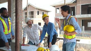 Group of architects and engineers work together to assess the residential home construction site's progress,256 photo