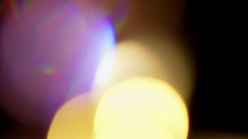 Multicolored light leaks 4k footage on black background. Lens studio flare leak burst overlays. Natural lighting lamp rays bokeh effect. For compositing over your footage, stylizing , transitions video