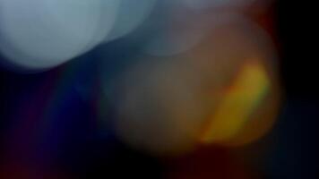 Multicolored light leaks 4k footage on black background. Lens studio flare leak burst overlays. Natural lighting lamp rays bokeh effect. For compositing over your footage, stylizing , transitions video