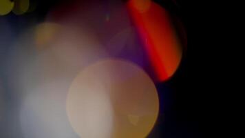 Multicolored light leaks 4k footage on black background. Lens studio flare leak burst overlays. Natural lighting lamp rays bokeh effect. For compositing over your footage, stylizing , transitions video