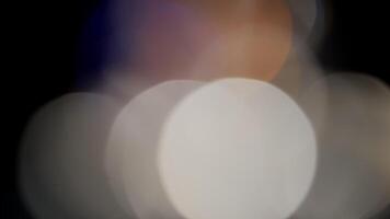 Multicolored light leaks 4k footage on black background. Lens studio flare leak burst overlays. Natural lighting lamp rays bokeh effect. For compositing over your footage, stylizing , transitions video