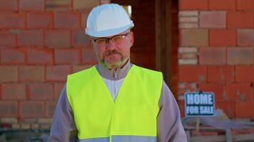 Portrait of civil engineer architect specialist raises thumbs up agrees with something or gives positive reply recommends advertisement likes good at construction site. Developer builder. Real estate video