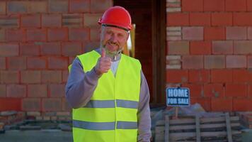 Civil engineer architect specialist raises thumbs up agrees with something or gives positive reply recommends advertisement likes good at construction site. Developer builder. Real estate home project video