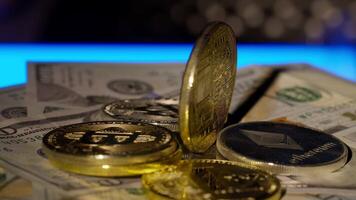 Bitcoin BTC coin and Ethereum ETH coins are rotating on bills cash of 100 dollars. Mining virtual money. Digital coin cyberspace and cryptocurrency. Stock exchange market trading, online payment video