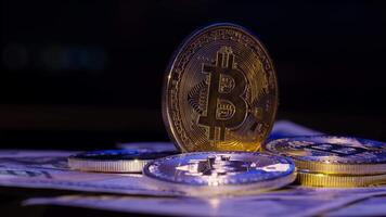 Bitcoin BTC coin and Ethereum ETH coins are rotating on bills cash of 100 dollars. Mining virtual money. Digital coin cyberspace and cryptocurrency. Stock exchange market trading, online payment video