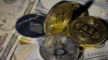Bitcoin BTC coin and Ethereum ETH coins are rotating on bills cash of 100 dollars. Mining virtual money. Digital coin cyberspace and cryptocurrency. Stock exchange market trading, online payment video