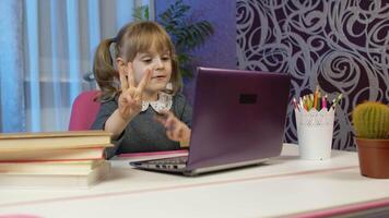 Child schoolgirl learns lessons teach mathematic and counting with teacher being at home using digital laptop computer. Kid pupil girl distance education. Studying on coronavirus quarantine lockdown video