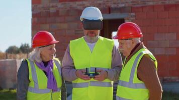 Specialist use drone on construction site. Architectural engineer, safety engineering inspector fly on building construction site controlling quality. Showing house to grandparents clients family video