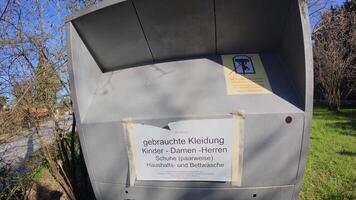 First person view of hands donating used items into a charity container in Germany. A simple act of kindness and social responsibility, helping people in need and supporting a sustainable lifestyle video