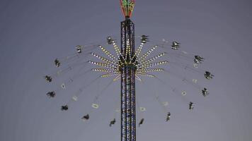 Star Flyer is worlds largest portable swing or chain carousel, standing at impressive height. Popular attraction at Oktoberfest in Munich, Bavaria, offering riders thrilling view of festival grounds. video