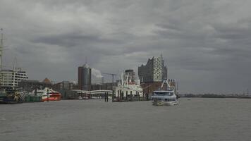 Discover Hamburg waterfront with its iconic Elbphilharmonie, bustling harbor and historic maritime charm. Vibrant mix of modern architecture, ships and scenic river views in Germany largest port city. video