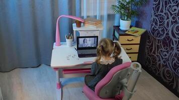Online learning, distance education, lesson at home, technology for kids. Girl doing school program online homework with teacher, using digital laptop computer. Education during coronavirus quarantine video