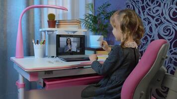 Child girl looking at web camera making call, learning geometric shapes at home. Online e-learning on internet, distance education with teacher. Lesson for children during coronavirus lockdown video