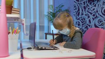 Cute kid pupil watching lesson, studying using digital laptop computer, doing homework. Preschool child girl distance online learning at home. Children remote education on covid-19 quarantine video