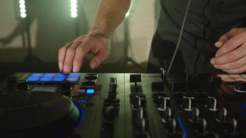 DJ composing new mix, dancing, performing on concert musician stage with lights. Live DJ performance of emotional energetic man with mixer controller. Party, music festival show concert. Slow motion video