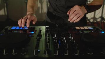 Live DJ performance of emotional energetic man with mixer controller. Composing new mix, dancing, performing on concert musician stage with lights. Party, music festival show concert. Slow motion video