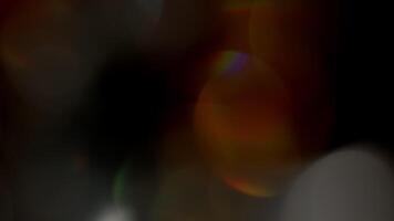 Multicolored light leaks 4k footage on black background. Lens studio flare leak burst overlays. Natural lighting lamp rays bokeh effect. For compositing over your footage, stylizing , transitions video