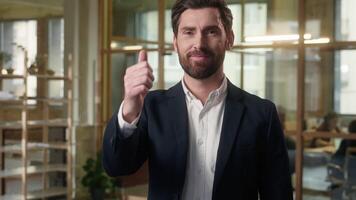 Business positive Caucasian man businessman demonstrating thumb up in office leader executive male looking at camera manager show approval sign worker smile agreement great result symbol guy recommend video