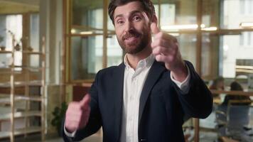 Glad Caucasian man business businessman pointing at camera thumbs up in office smiling entrepreneur executive gesturing you manager guy male showing approve gesture good job excellent result success video