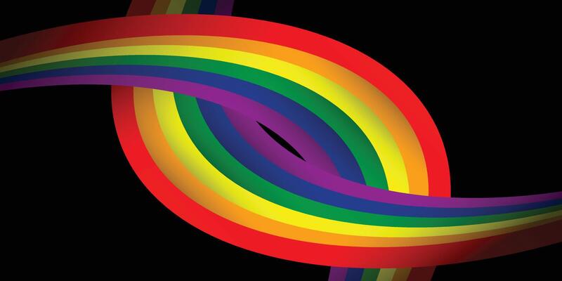 Dynamic wave of rainbow LGBTQ pride flag on dark background, celebration