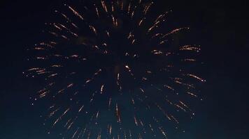 Dazzling fireworks illuminating dark night sky with bursting, sparkling colorful explosions during festive celebration event. video