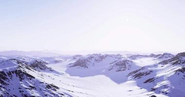 CGI Snow covered mountains under a clear sky at dawn video