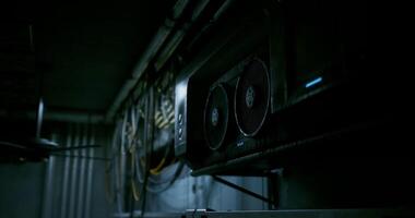 CGI High tech gaming rig in a dimly lit workspace with cables and ventilation video