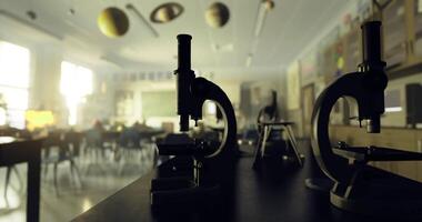 CGI Microscopes and a science classroom with planets hanging from the ceiling video