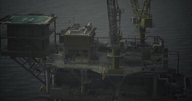 CGI Offshore oil platform operates near calm ocean waters at dusk video