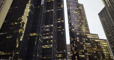 CGI Modern urban skyscrapers reflect city life at twilight in a bustling area video