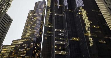 CGI Modern urban buildings illuminated at dusk in a bustling city video