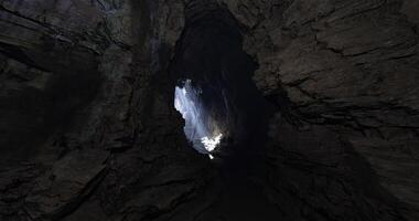 CGI Light pours into a dark cavern revealing stunning rock formations video