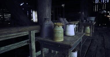 CGI Vintage milk cans and jars lined on wooden tables in a rustic barn setting video