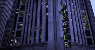 CGI Bright lights illuminate the theater building in the city at dusk video