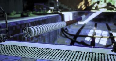 CGI Swimming pool maintenance equipment next to a clean pool on a sunny day video